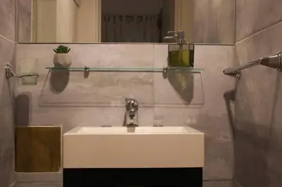 a bathroom with a white sink and a mirror at Nuevo Abrojal: departamento en Barrio Güemes in Cordoba