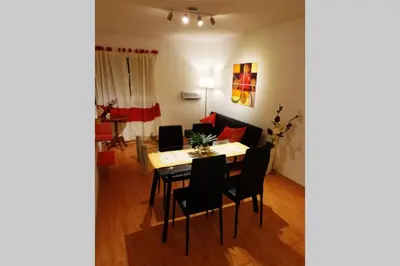 a dining room and living room with a table and chairs at Nuevo Abrojal: departamento en Barrio Güemes in Cordoba