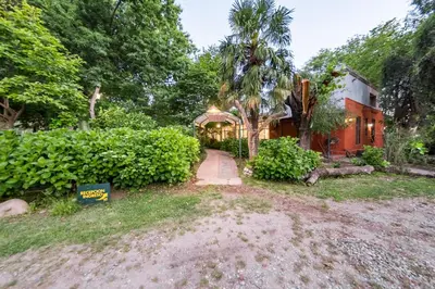 a home with a driveway leading to a house at Posada El Pucara in San Javier