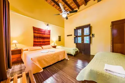 a bedroom with two beds and a ceiling at Posada El Pucara in San Javier