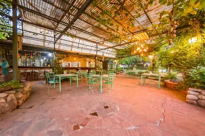a patio with tables and chairs in a building at Posada El Pucara in San Javier