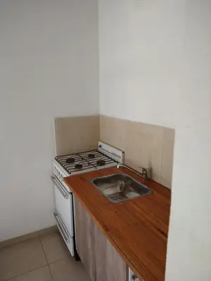 a kitchen with a stove and a sink at El diquecito duplex in Casa Bamba
