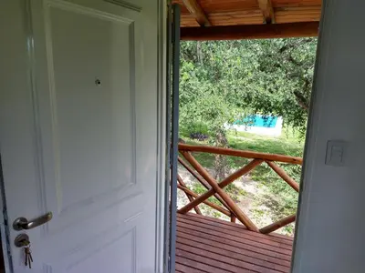 an open door with a view of a deck at El diquecito duplex in Casa Bamba