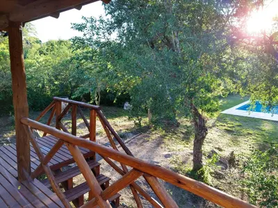 a view from the deck of a house with a tree at El diquecito monoambiente in Casa Bamba