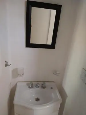 a bathroom with a sink and a mirror on the wall at El diquecito monoambiente in Casa Bamba