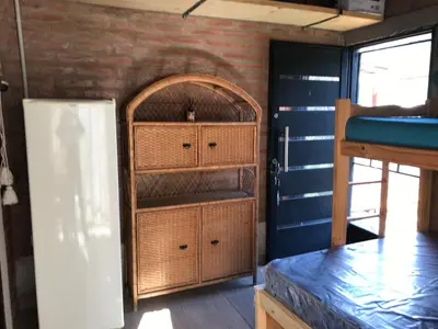 a room with a bunk bed next to a door at Inti Huasi in La Paisanita