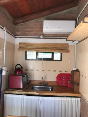 a kitchen with a sink and a red appliance at Inti Huasi in La Paisanita
