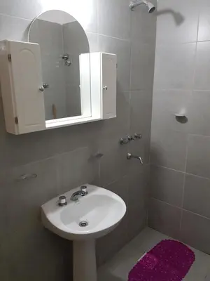 a bathroom with a white sink and a mirror at Casa Kassel in Villa Cura Brochero