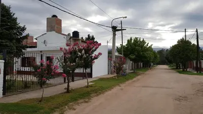 a street with a white house with a fence at Casa Kassel in Villa Cura Brochero