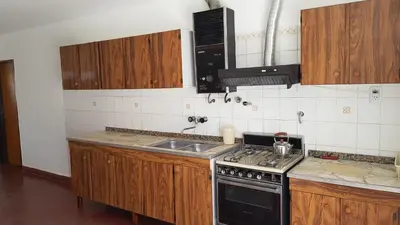 a kitchen with a stove and a sink at Casa Kassel in Villa Cura Brochero
