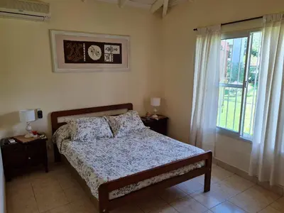 a bedroom with a bed and a window at Casa Anémona in Merlo