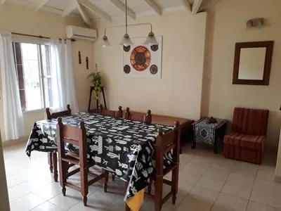 a dining room with a black and white table and chairs at Casa Anémona in Merlo