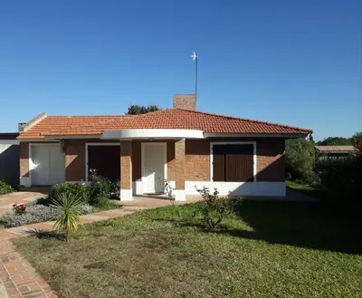 a brick house with a red roof at Casa Anémona in Merlo