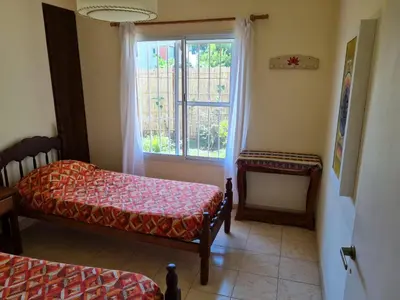 a room with two beds and a window at Casa Anémona in Merlo