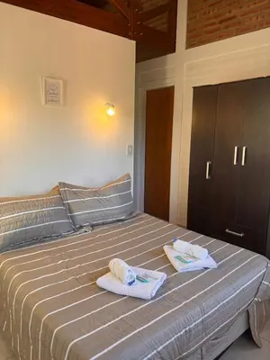 a bedroom with a bed with towels on it at Hotel Aimara in Mina Clavero