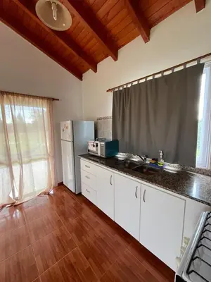 a kitchen with a counter top and a refrigerator at Hotel Aimara in Mina Clavero