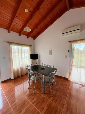 a dining room with a black table and chairs at Hotel Aimara in Mina Clavero