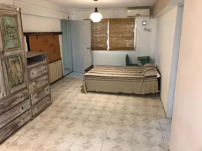 a bedroom with a bed and a dresser in it at Casa Miradores del Lago in Bialet Massé