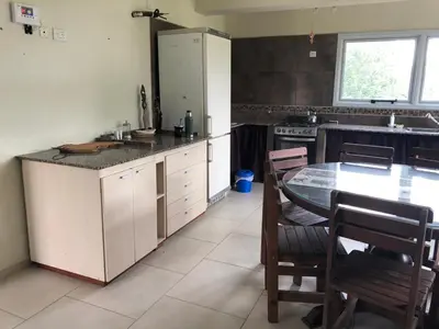 a kitchen with a table and a counter top at Casa Miradores del Lago in Bialet Massé