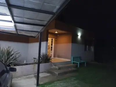 a house with stairs and a green bench in the dark at Casa Miradores del Lago in Bialet Massé
