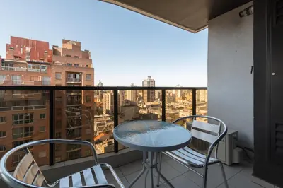 a table and chairs on a balcony with a view at AT Suites in Cordoba