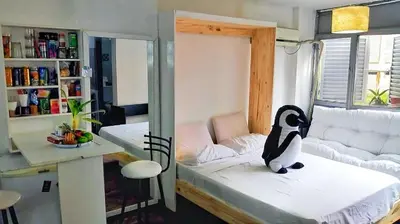 a room with a penguin sitting on a bed at Departamento del centro in Cordoba