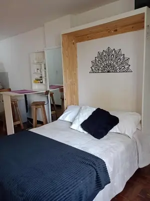 a bedroom with a bed with a black and white comforter at Departamento del centro in Cordoba
