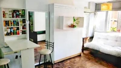 a living room with a white couch and a table at Departamento del centro in Cordoba