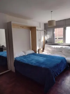 a bedroom with two beds with a blue blanket at Departamento del centro in Cordoba
