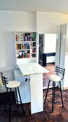 a kitchen with two chairs and a table and a counter at Departamento del centro in Cordoba