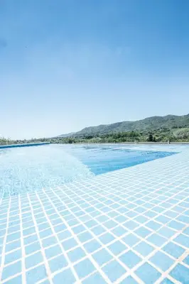 a view of a beach with water and mountains in the background at Cabaña Modestita - FINCA PUDUAM in Villa General Belgrano