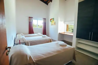 a hospital room with two beds and a window at Cabaña Sol - FINCA PUDUAM in Villa General Belgrano