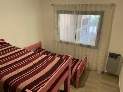 a bedroom with two beds and a window at Casa EBEL in Alpa Corral