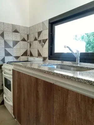 a kitchen with a sink and a window at Casa EBEL in Alpa Corral
