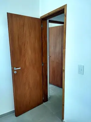 an open door in a room with a wooden door at Casa EBEL in Alpa Corral