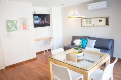 a living room with a glass table and a couch at Guemes Apart Nueva Cordoba in Cordoba