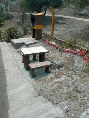 a picnic table and bench in a park at Casa de Alquiler 1 in Tanti