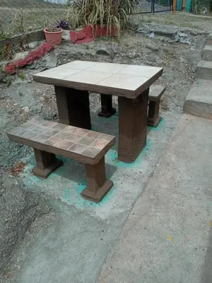 a picnic table and two benches on a sidewalk at Casa de Alquiler 1 in Tanti