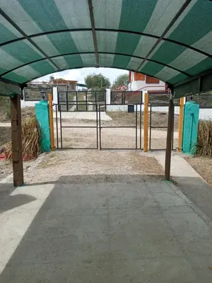 a tennis court with a green covering over a gate at Casa de Alquiler 1 in Tanti
