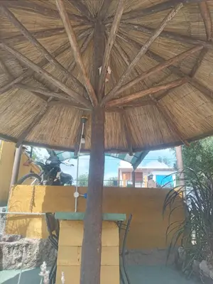 a table under a straw umbrella in a restaurant at Casa de Alquiler 1 in Tanti
