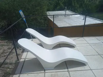two white benches sitting on top of a patio at Casa de Alquiler 1 in Tanti