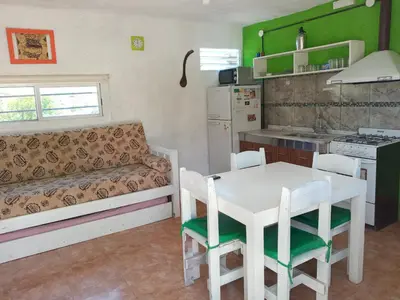 a kitchen with a table and a couch in a room at Casa de Alquiler 1 in Tanti