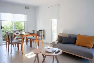 a living room with a couch and a table at Be mas apartamentos boutique Villa Gral Belgrano in Villa General Belgrano