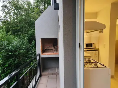 a view of a balcony with a stove top oven at Be mas apartamentos boutique Villa Gral Belgrano in Villa General Belgrano