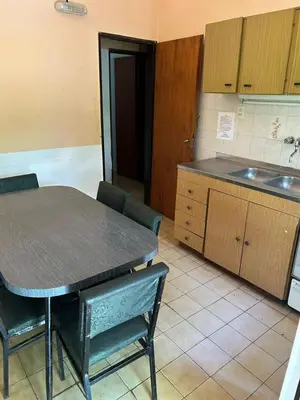 a kitchen with a table and chairs and a sink at La Luisa in Merlo