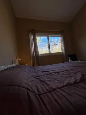 a bedroom with a large bed and a window at La Luisa in Merlo
