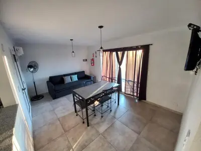 a living room with a table and a couch at Luces Casas de Montaña in Villa del Dique