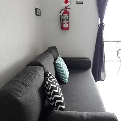 a couch with pillows on it in a living room at Luces Casas de Montaña in Villa del Dique