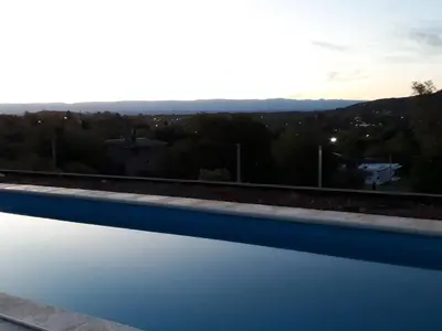 a swimming pool with a view of the mountains at Luces Casas de Montaña in Villa del Dique