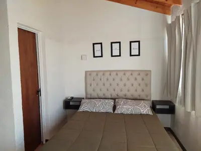a bedroom with a bed with two pillows on it at Loma Alta Apart in Villa Yacanto